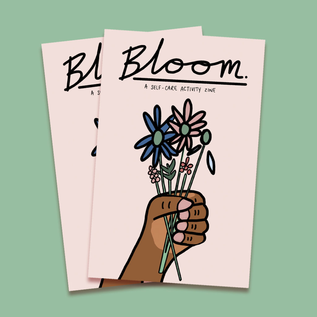 Photo of Bloom zine cover featuring a hand holding flowers