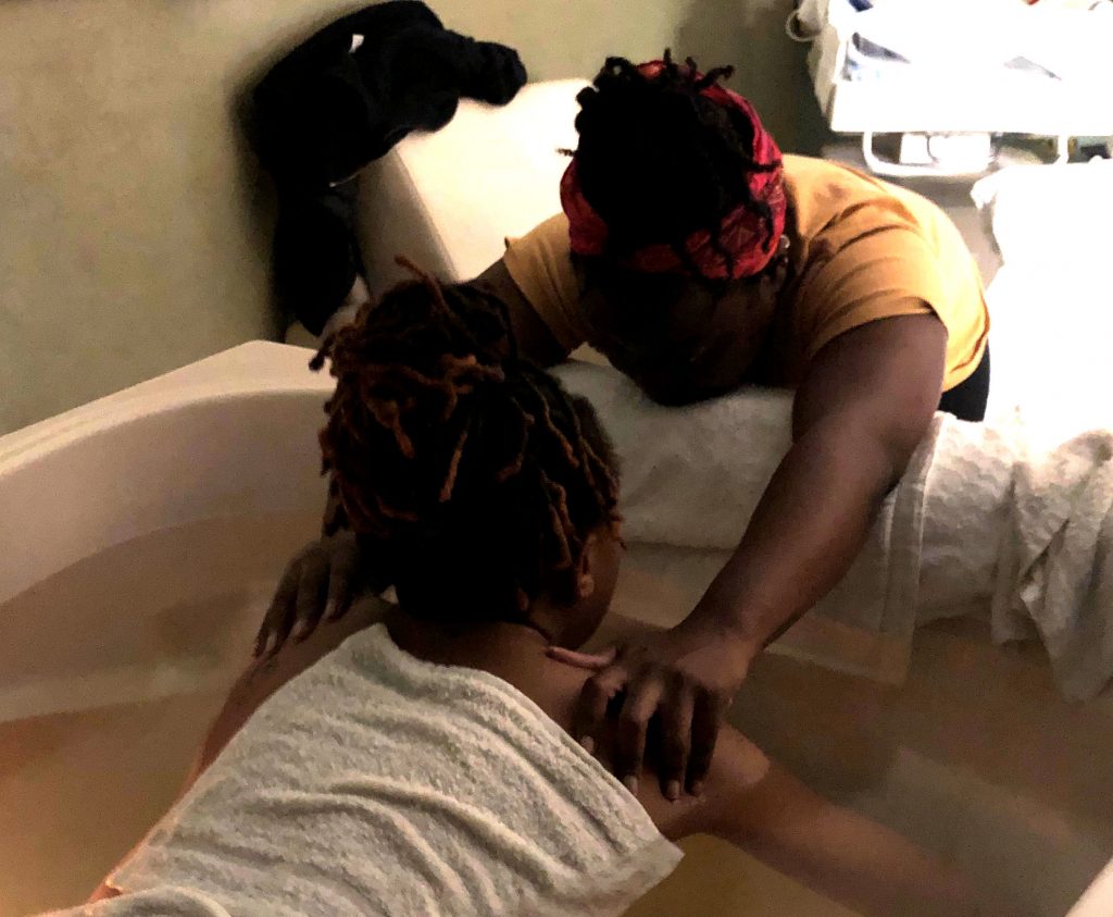 Karasi Doula with client in birthing tub